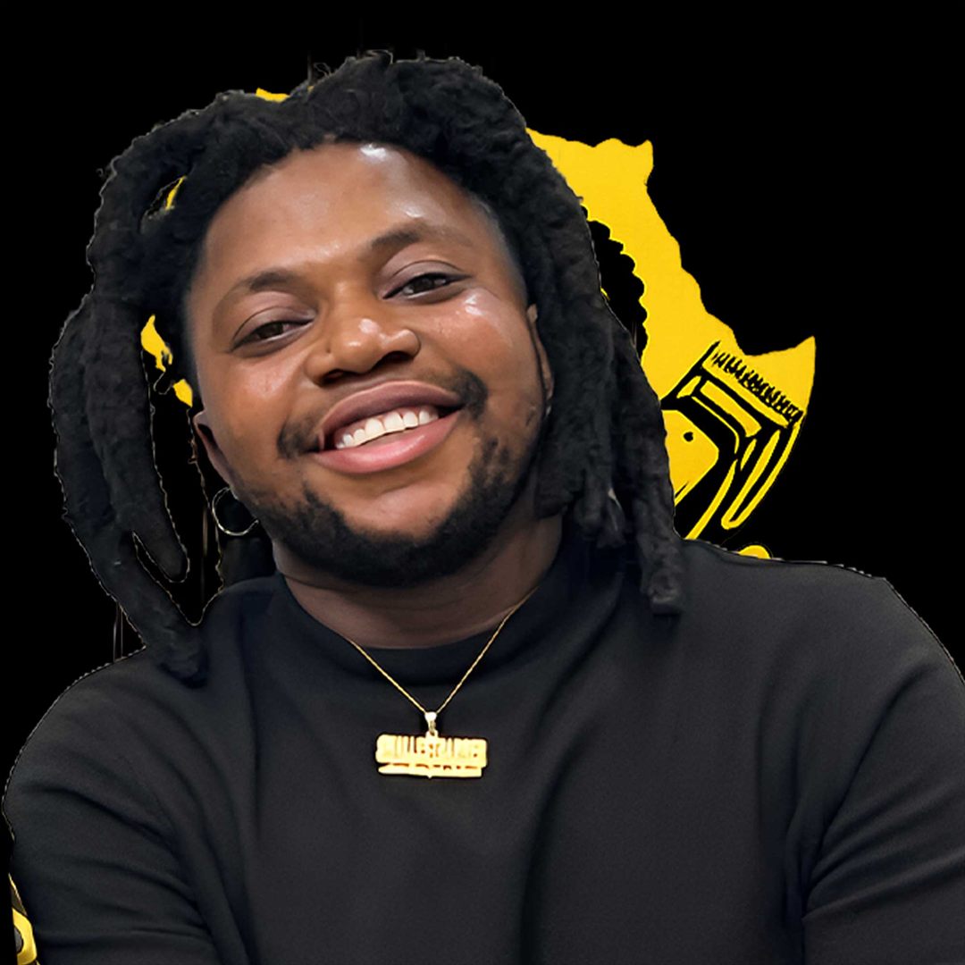 Portrait of Smallest Barber, smiling, with locs and a gold chain, against a gold Africa graphic.